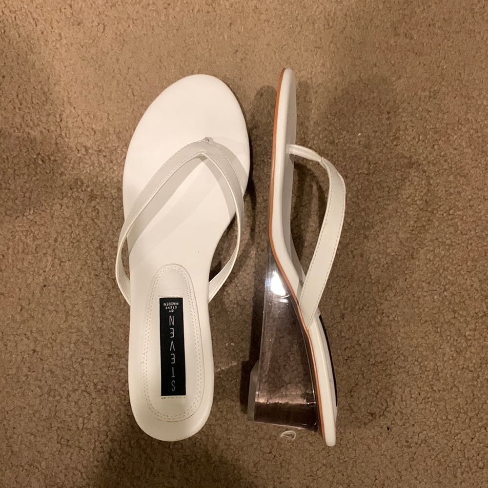White thong sandals with a 1 inch clear heel